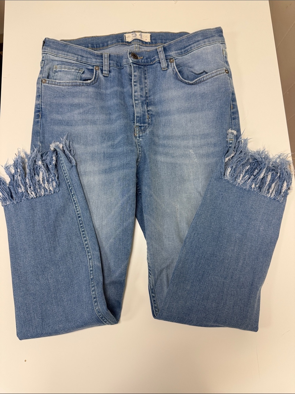NWOT We are free size 31 light wash blue jeans with fringe bottom